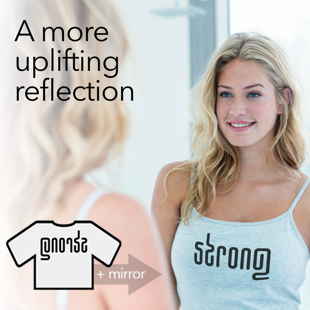 Woman in the mirror wearing an uplifting, inspirational, and motivating shirt that says "strong" in her reflection.